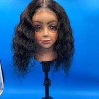 A mannequin head with long hair on top of it.