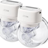 A pair of clear cups with white lids.